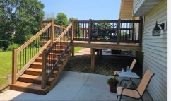Deck stairs down to a paver patio